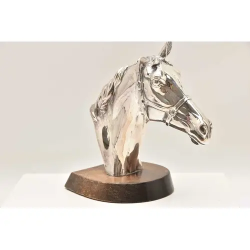 A MOUNTED FILLED SILVER HORSE HEAD, fitted on a wooden base,...