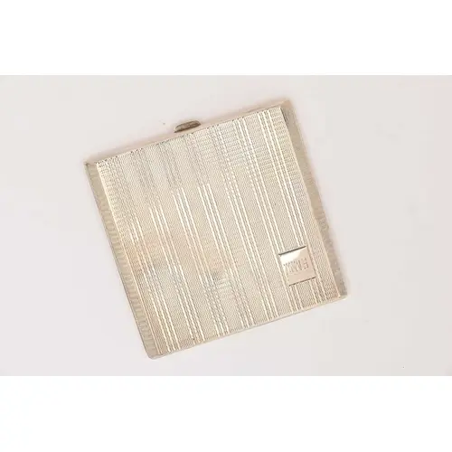 A GEORGE VI SILVER COMPACT, a square form compact with engin...