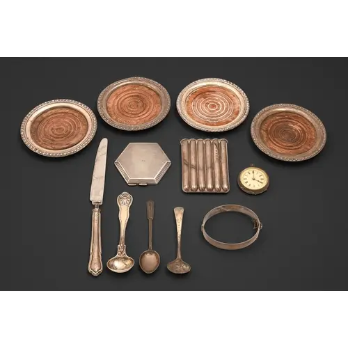 A set of four North American silver coasters, 20th c, with g...