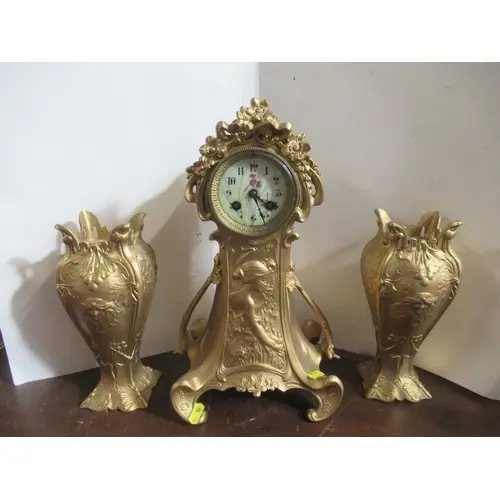 An Art Nouveau clock garniture, the clock with floral decora...