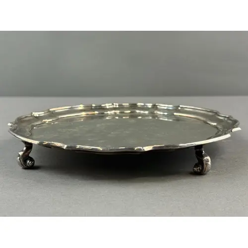 Silver: a plain silver salver with piecrust rim and standing...