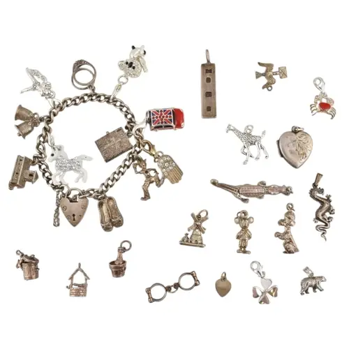 Silver charm bracelet with additional charms. Chain link sta...