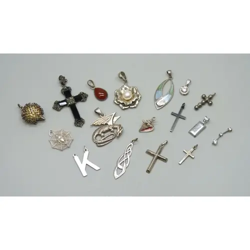 A collection of silver and white metal pendants, 48g
