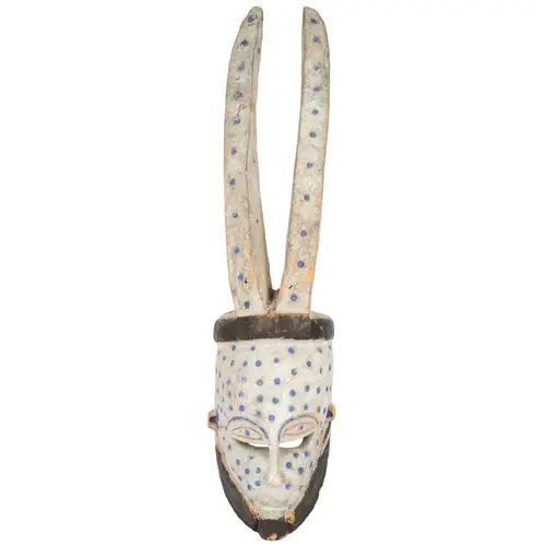 An Edo-Bini Azigho white and blue painted horned tribal mask...
