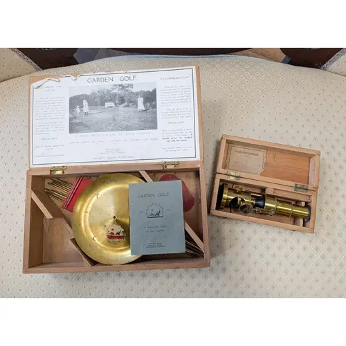 A vintage set of garden golf in box and a brass French micro...