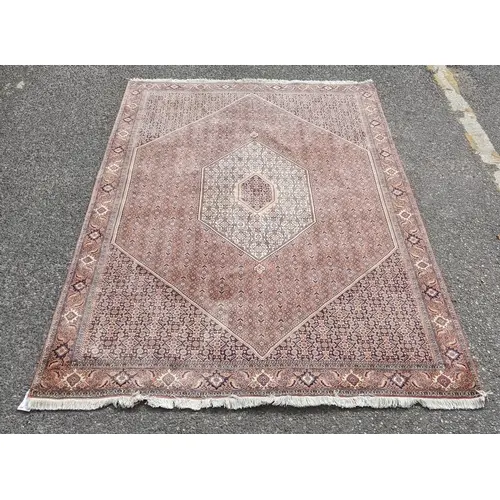 A Persian Bijar rug with an intricate symmetrical design env...
