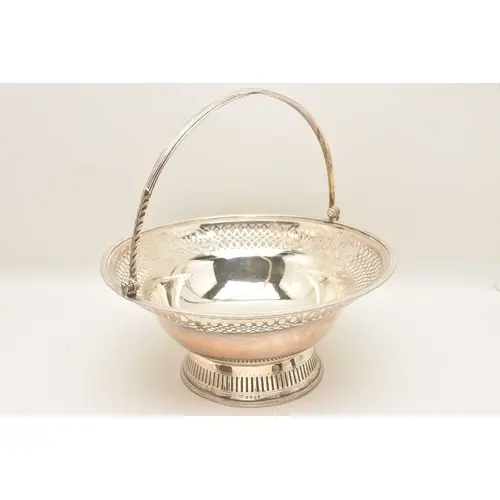 A GEORGE III SILVER BREAD BASKET, with pierced scrolling and...