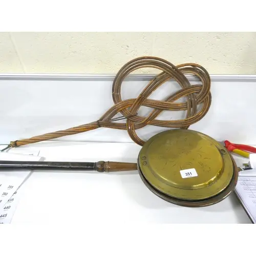 Vintage carpet beater and brass bed warmer.