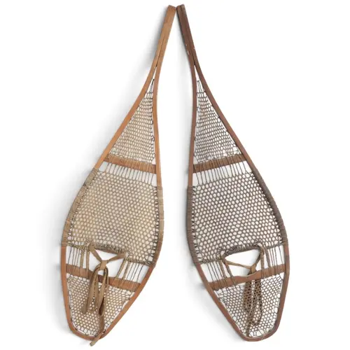 A pair of Native American snow shoes with rawhide lacing, le...
