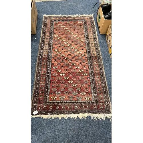 Eastern red ground rug, the field decorated with stylised fl...