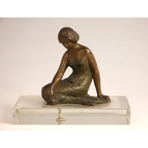 A patinated bronze Art Nouveau style figure of small proport...