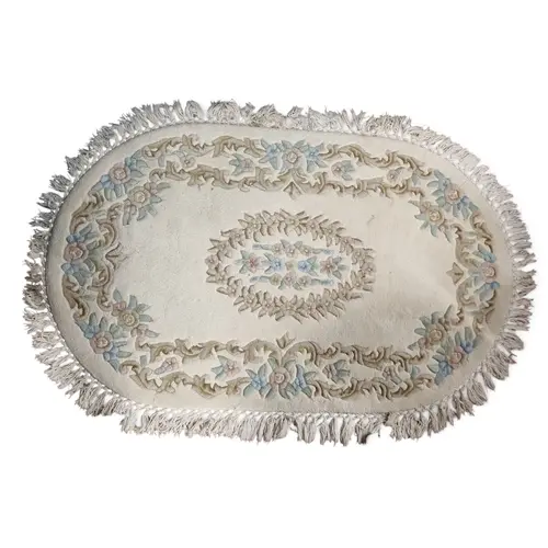 An Oriental cream ground oval Rug with floral outline. 180 x...