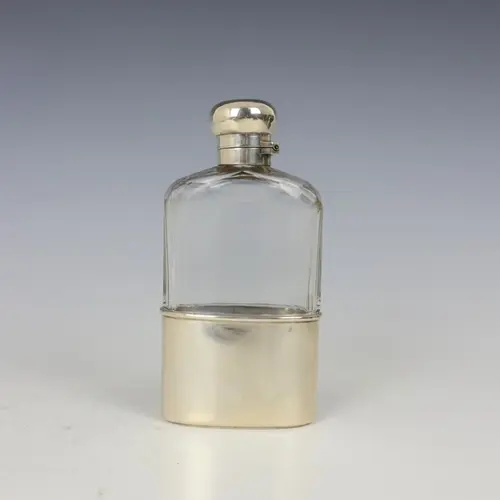A Victorian silver mounted glass hipflask, London 1897, the ...