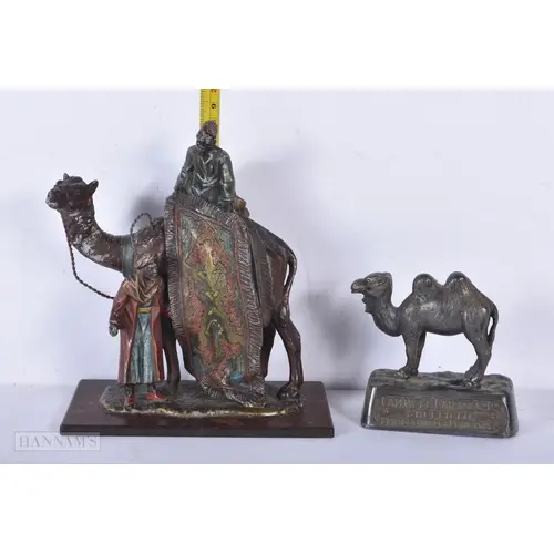A Bergman style spelter Arab rug seller on a camel together ...