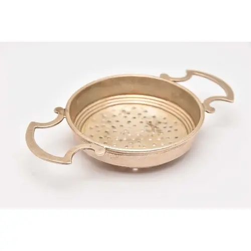 A MID 20TH CENTURY SILVER STRAINER, fitted with twin open wo...