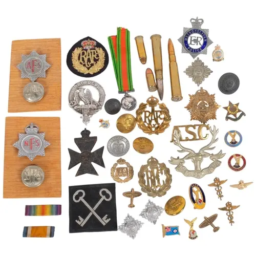 A collection of military badges, medals, etc
