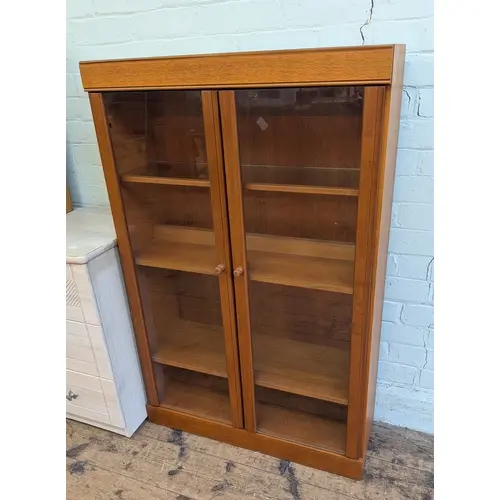 A small modern teak two door glazed bookcase, 2'6" wide