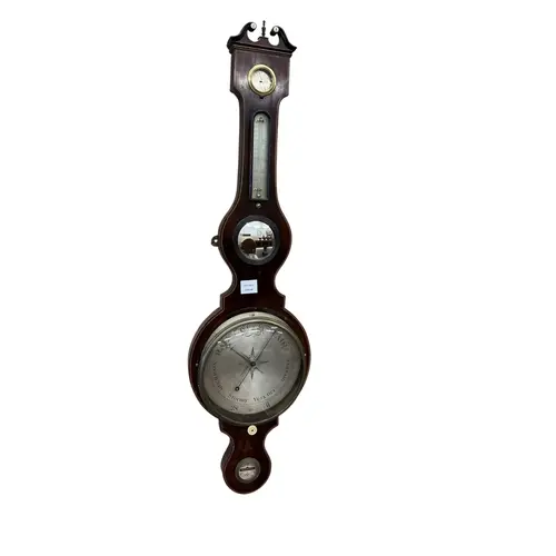 An early 19th century mahogany wheel barometer, with swan ne...