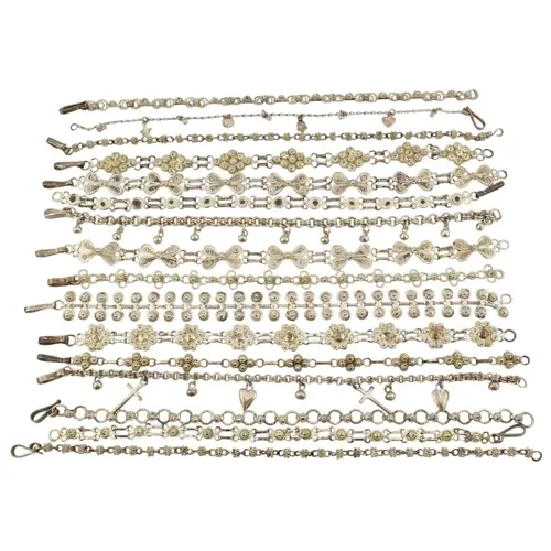 Collection of silver and white metal filigree bracelets. To ...
