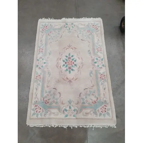 A Chinese style Rug on beige ground with floral border and c...