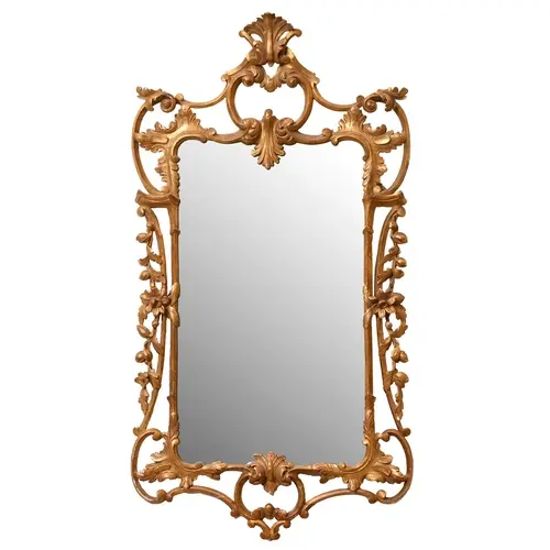 A George III rococo giltwood mirror, carved with C-scrolls a...