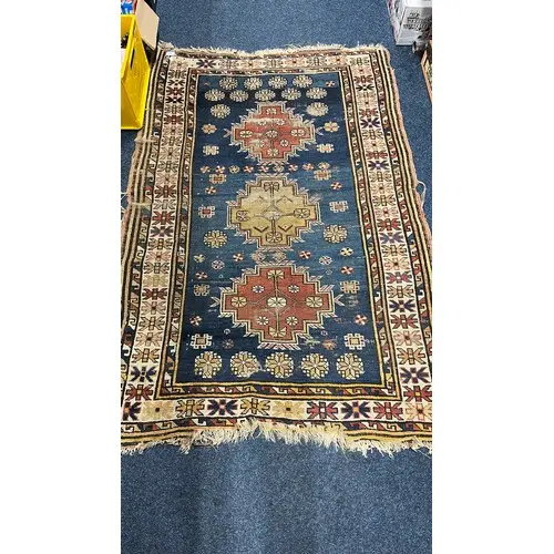 Eastern blue ground rug having triple gul medallion field, 1...
