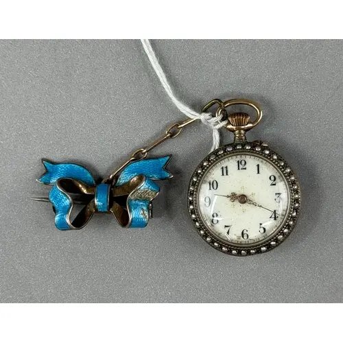 Watches: a Swiss silver gilt cased brooch pin set watch on b...