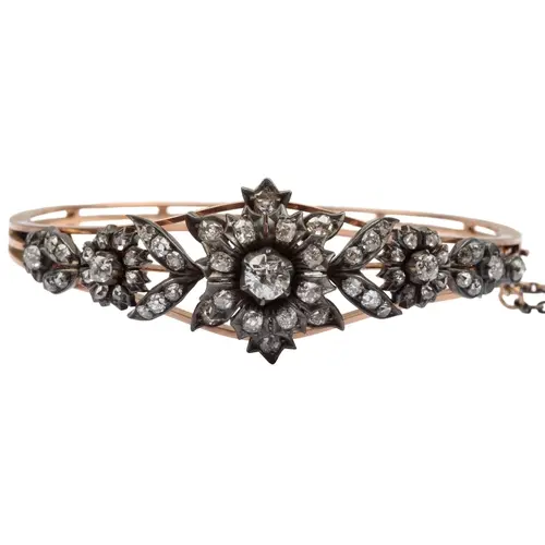 A Victorian diamond bangle, late 19th century, the hinged go...