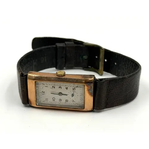 A 9ct gold watch, makers mark B W C, on leather strap....