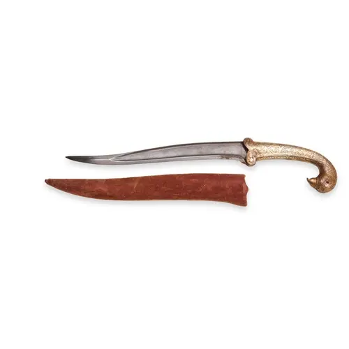 A GILT-OVERLAID IRON PARROT'S HEAD-HILTED DAGGER AND SCABBAR...