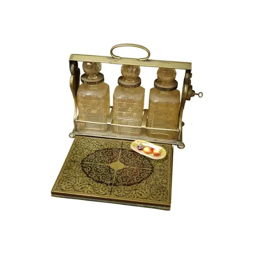 A Victorian silver plated tantalus, a mid 19th century brass...