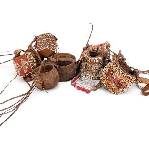 A group of Vintage African Tribal baskets, with cowrie shell...