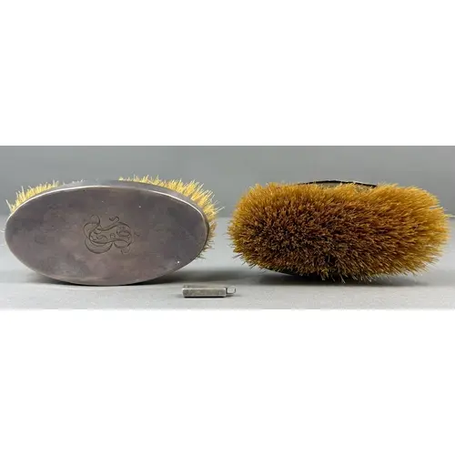 Silver: a pair of silver backed clothes brushes, London 1902...