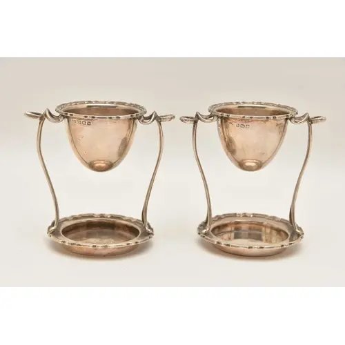 A PAIR OF EALRY 20TH CENTURY SILVER EGG CUP STANDS, both wit...