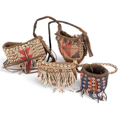 A group of Vintage African Tribal baskets, with cowrie shell...
