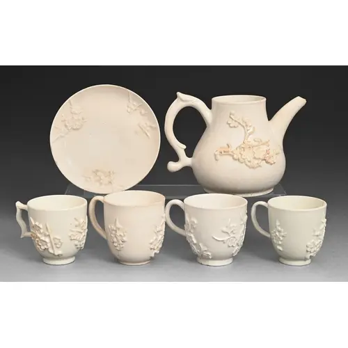 A Bow prunus sprigged teapot, four coffee cups and a saucer,...