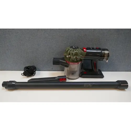 A Dyson V8 Cyclone stick vacuum cleaner with charger, origin...