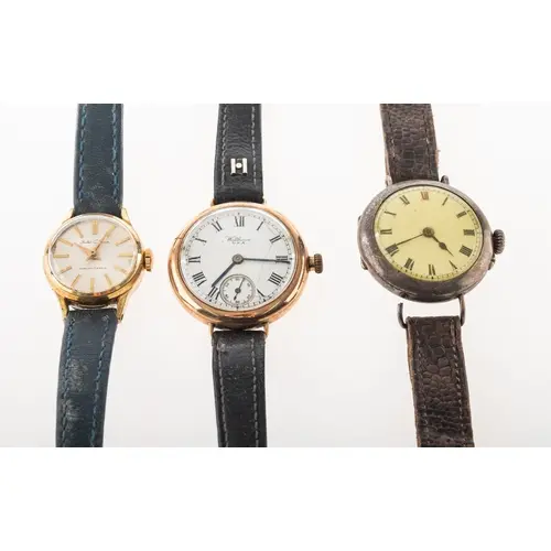 Waltham a 9K gold wristwatch and two others the white enamel...