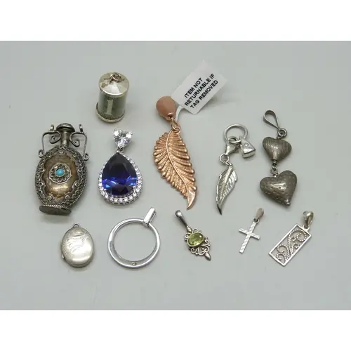 A collection of silver and white metal pendants, 43g