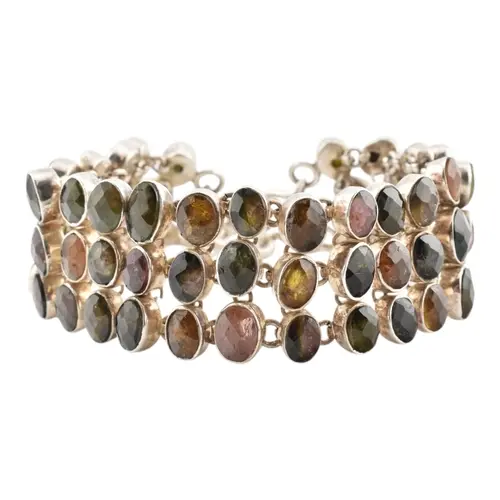 A silver gem set bracelet. The bracelt set with set with col...