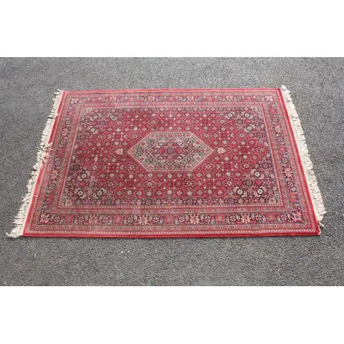 Hand-knotted Persian Mashad rug, of red-ground having blue a...