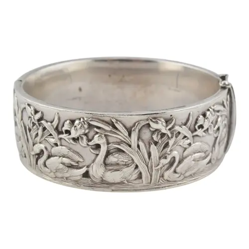 A hallmarked Continental silver Arts and Crafts hinged bangl...