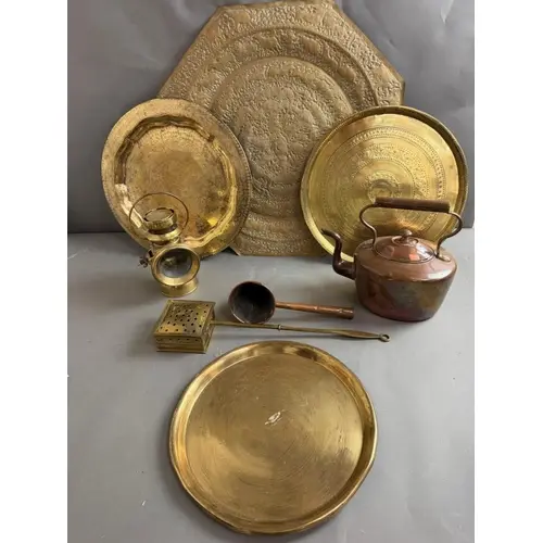 A selection of brass trays, a side lamp, and a copper water ...