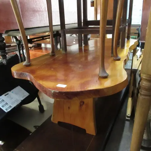 Mid 20th Century stained pine raw edge coffee table with a s...