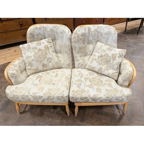A blond Ercol two seater sofa - in two sections with beige a...