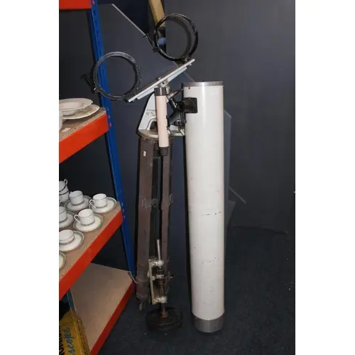 Large vintage telescope on tripod stand.