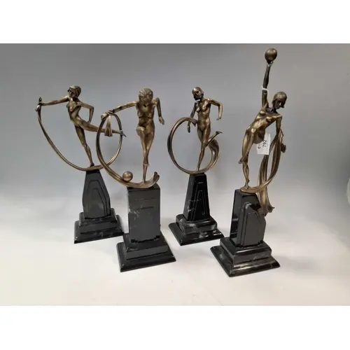 A GROUP OF FOUR COMPOSITE BRONZE EFFECT ART DECO STYLE FIGUR...