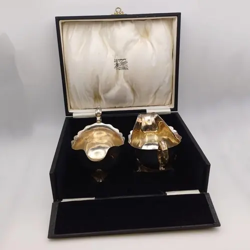 A CASED PAIR OF SILVER SAUCE BOATS ON 3 HOOF FEET BY JAMES C...
