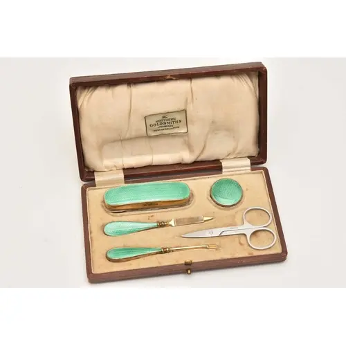 A CASED SILVER GILT AND GREEN ENAMEL ART DECO MANICURE SET, ...