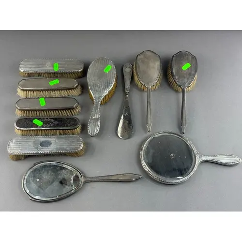 Silver: a group of dressing table items, to include two mirr...